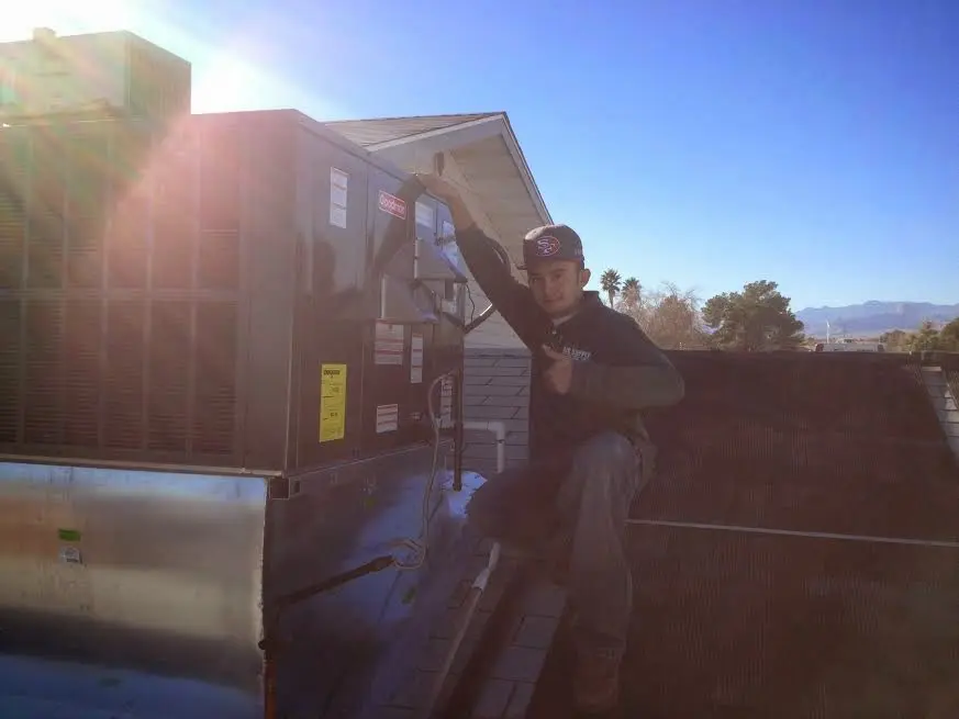 HVAC technician performing HVAC Inspection on a rooftop unit in Apple Valley